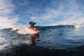 December 28, 2019. Anapa, Russia. Surfer in wetsuit on longboard with sea wave. Winter surfing in Russia