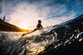 December 28, 2019. Anapa, Russia. Surfer in wetsuit on longboard with sea wave. Winter surfing in Russia