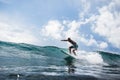 December 30, 2020. Bali, Indonesia. Surfer ride on surfboard at ocean wave. Professional surfing at perfect waves