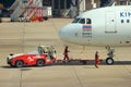 2018 December 14. Bangkok Thailand. airport ground worker moving an Air Asia airline plane to prepare for take off.