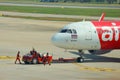 2018 December 14. Bangkok Thailand. airport ground worker moving an Air Asia airline plane to prepare for take off.