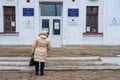 December 5, 2021 Beltsy, Moldova. The back of a woman going to the polls. A polling station in a typical school