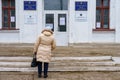 December 5, 2021 Beltsy, Moldova. The back of a woman going to the polls. A polling station in a typical school