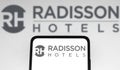 December 8, 2021, Brazil. In this photo illustration the Radisson Hotels logo seen displayed on a smartphone and on the background Royalty Free Stock Photo