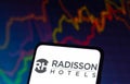 December 8, 2021, Brazil. In this photo illustration the Radisson Hotels logo seen displayed on a smartphone and in the background Royalty Free Stock Photo