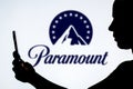 December 9, 2023, Brazil. A woman\'s silhouette holds a smartphone with the Paramount Global logo in