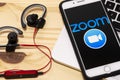 Smartphone showing Zoom Cloud meetings application logo on an a screen