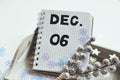 winter decorations next to handwritten december 6 write in notepad Royalty Free Stock Photo