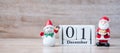 1 December calendar with Christmas decoration, snowman, Santa claus and pine tree  on wooden table background, preparation for Royalty Free Stock Photo