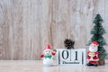 1 December calendar with Christmas decoration, snowman, Santa claus and pine tree  on wooden table background, preparation for Royalty Free Stock Photo