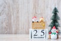 25 December calendar with Christmas decoration, snowman, Santa claus and pine tree  on wooden table background, preparation for Royalty Free Stock Photo