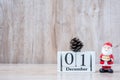 1 December calendar with Christmas decoration, snowman, Santa claus and pine tree  on wooden table background, preparation for Royalty Free Stock Photo