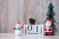 1 December calendar with Christmas decoration, snowman, Santa claus and pine tree  on wooden table background, preparation for Royalty Free Stock Photo