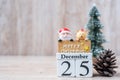 25 December calendar with Christmas decoration, snowman, Santa claus and pine tree  on wooden table background, preparation for Royalty Free Stock Photo