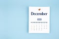 December 2026 calendar page with push pin on blue background Royalty Free Stock Photo