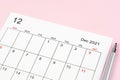 December 2021 calendar sheet with pen on pink background Royalty Free Stock Photo