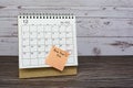 December 2022 calendar on wooden desk with date circle and text on sticky note. Royalty Free Stock Photo