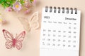 A December 2023 desk calendar for the organizer to plan, reminder and butterfly paer with flower on yellow background