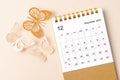 A December 2023 desk calendar for the organizer to plan and reminder and butterfly paer on yellow background