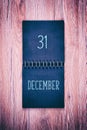 31. December. Desk calendar on wooden background. New year background. Royalty Free Stock Photo