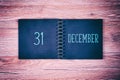 31. December. Desk calendar on wooden background. New year background. Royalty Free Stock Photo