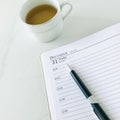 December 31, the last page of the diary and a pen and a cup of tea on white marble background , square. Royalty Free Stock Photo