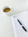 December 31, the last page of the diary and a pen and a cup of tea on white marble background , vertical. Royalty Free Stock Photo