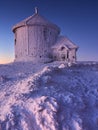 December 18, 2022, Karpacz, Poland. Snow-covered Chapel of Saint Lawrence on Mount Sniezka before sunrise. Karkonosze