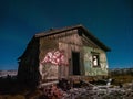 An old dilapidated house under a starry sky. Teriberka. Russia