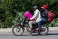 Dramatic image of motor bike with two people and two suitcases