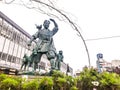 2018 December 06. Okayama Japan. A old Momotaro statue sculpture standing front of Okayama train station with rainy sky background