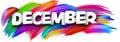 December paper word sign with colorful spectrum paint brush strokes over white Royalty Free Stock Photo