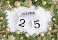 25 december perpetual calendar Christmas greeting card design Green frame made of Christmas trees and golden decorations Royalty Free Stock Photo