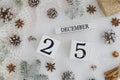 25 december perpetual calendar on white Background decorated Christmas Decoration Tree branches with snow,fir cones Royalty Free Stock Photo