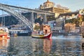 09 of December, 2018 - Porto, Portugal: View of the historic city with the Dom Luiz bridge. A metro train can be seen on the