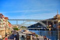 09 of December, 2018 - Porto, Portugal:  View of the historic city with the Dom Luiz bridge. A metro train can be seen on the Royalty Free Stock Photo