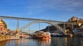 09 of December, 2018 - Porto, Portugal:  View of the historic city with the Dom Luiz bridge. A metro train can be seen on the Royalty Free Stock Photo