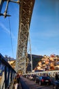 09 of December, 2018 - Porto, Portugal:  View of the historic city with the Dom Luiz bridge. A metro train can be seen on the Royalty Free Stock Photo