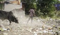 December, 2022, Raipur, India: Man sweeping the trash with broom and polyhthene big garbage area, Man cleaning the polluted area,