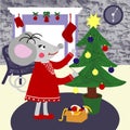 Rat or mouse decorates a Christmas tree with balls and garland, cozy house on background Royalty Free Stock Photo