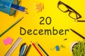 December 20th. Day 20 of december month. Calendar on yellow businessman workplace background. Winter time