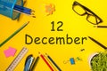 December 12th. Day 12 of december month. Calendar on yellow businessman workplace background. Winter time
