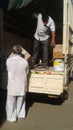 Unloading goods from local transport, Maharashtra, India