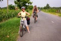 28 DECEMBER 2016, Vietnam, Can Txo. Two travelers on bicycles. Vietnamese tourism. Mekong Delta among rice fields Royalty Free Stock Photo