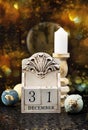 31 December wooden calendar, vintage Christmas balls and antique clock.
