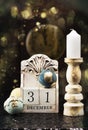 31 December wooden calendar, vintage Christmas balls and antique clock.