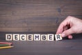 December. Wooden letters on the office desk, informative and communication background