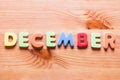 December word written with colorful letters on wooden background