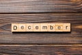 December word written on wood block. December text on wooden table for your desing, Top view concept