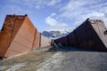 Deception Island, Antarctica. Sunken tanks of abandoned whale station with cruise liner in background. Lost places.